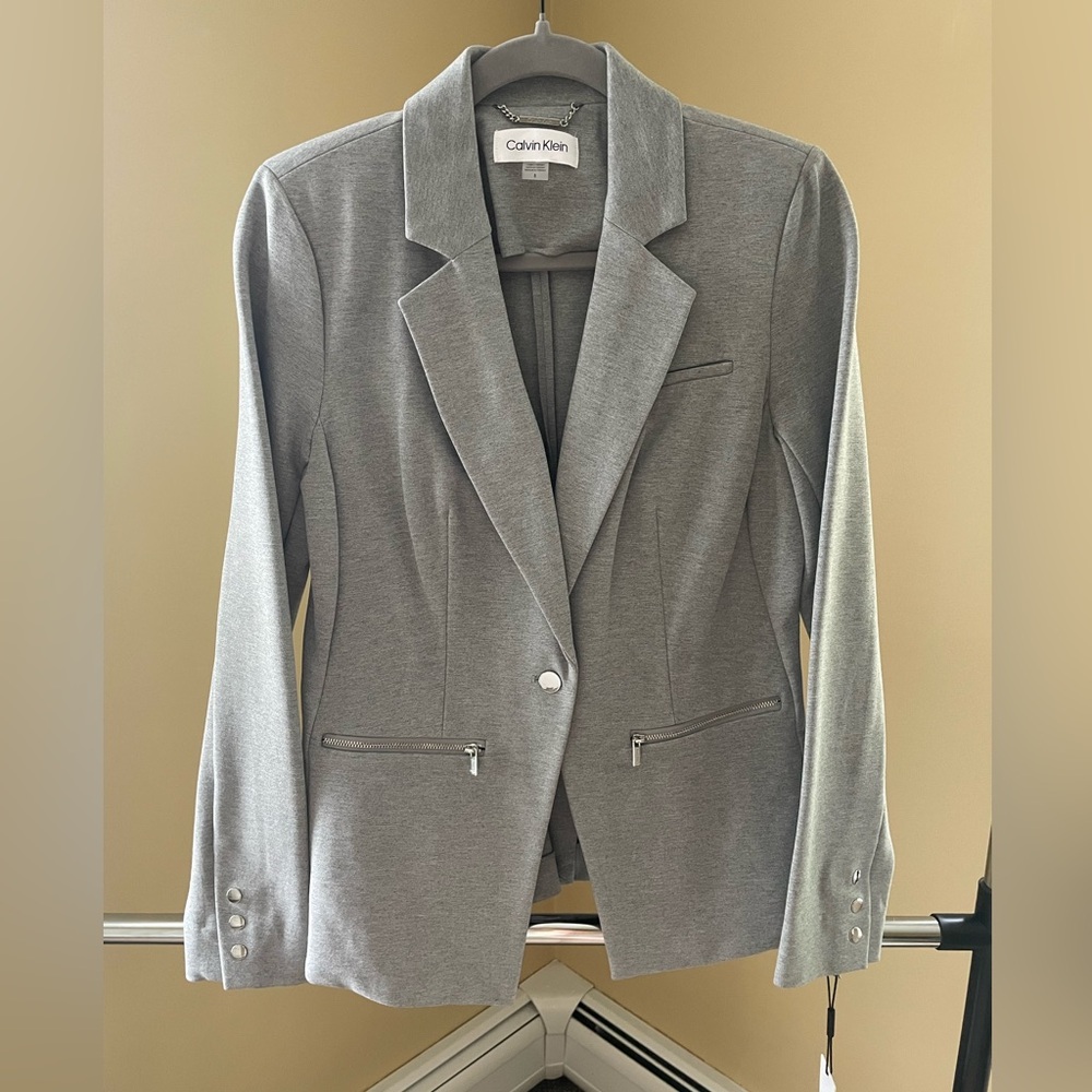 Gray suit blazer with front zipper pockets